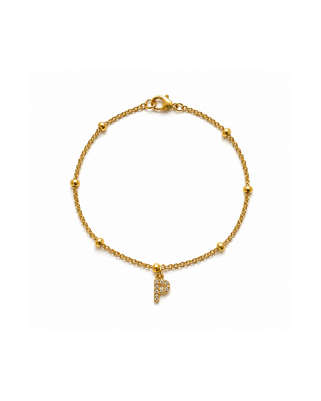 A delicate gold-plated beaded chain bracelet and a dangling initial 'P' charm paved with clear zircon stones.