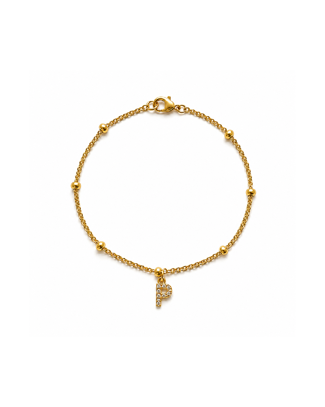 A delicate gold-plated beaded chain bracelet and a dangling initial 'P' charm paved with clear zircon stones.